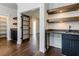 Butlers pantry with dark cabinetry, granite countertop and wine storage at 142 Lila Dr, Pittsboro, NC 27312