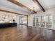 Open concept dining area with hardwood floors and exposed beams at 142 Lila Dr, Pittsboro, NC 27312