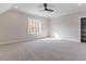 Spacious bedroom with carpeted floor, large window, and ceiling fan at 142 Lila Dr, Pittsboro, NC 27312