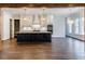 Modern kitchen with dark lower cabinets, white upper cabinets, and a large island at 142 Lila Dr, Pittsboro, NC 27312