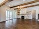 Spacious Gathering room with hardwood floors, exposed beams, and a fireplace at 142 Lila Dr, Pittsboro, NC 27312
