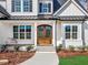 Elegant front entry with double doors and a stone walkway at 142 Lila Dr, Pittsboro, NC 27312