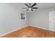 Well-lit bedroom with hardwood floors and ceiling fan at 114 Glosson Cir, Carrboro, NC 27510