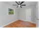 Simple bedroom with hardwood floors, ceiling fan and window at 114 Glosson Cir, Carrboro, NC 27510