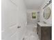 Updated bathroom with a bathtub, marble flooring and modern vanity at 114 Glosson Cir, Carrboro, NC 27510