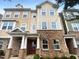 Brick townhouse with a red front door at 6631 Perry Creek Rd, Raleigh, NC 27616