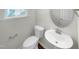 Stylish half bathroom with pedestal sink and toilet at 6631 Perry Creek Rd, Raleigh, NC 27616