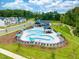 Community pool with lounging areas and clubhouse at 659 Georgias Landing Pkwy # 100, Raleigh, NC 27603