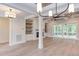 Spacious living room with hardwood floors, fireplace, built-in shelves, and access to a screened porch at 10 Harvest View Way, Franklinton, NC 27525