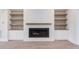 Modern fireplace with built-in shelving and wood mantel at 10 Harvest View Way, Franklinton, NC 27525