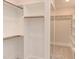 Spacious walk-in closet with built-in shelves and hanging rods at 10 Harvest View Way, Franklinton, NC 27525