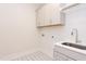 Laundry room with cabinets, sink and patterned floor at 10 Harvest View Way, Franklinton, NC 27525