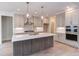 Spacious kitchen featuring a large island, stainless steel appliances, and white cabinets at 10 Harvest View Way, Franklinton, NC 27525