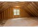 Unfinished attic space with wood framing and window at 10 Harvest View Way, Franklinton, NC 27525