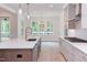 Bright kitchen with white cabinets, stainless steel appliances, and a large island at 10 Harvest View Way, Franklinton, NC 27525
