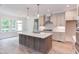 Modern kitchen with large island, stainless steel appliances, and white cabinets at 10 Harvest View Way, Franklinton, NC 27525