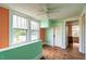 Bedroom with hardwood floors, teal and orange walls and ceiling fan at 359 Trollingwood Rd, Haw River, NC 27258