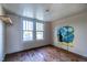 Charming bedroom with wood floors, unique wall art, and ample natural light at 359 Trollingwood Rd, Haw River, NC 27258