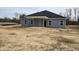 Rear view showing a covered patio and yard at 22 Capeside Ct, Lillington, NC 27546