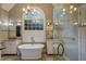 Elegant bathroom featuring a soaking tub, dual vanities, and a separate shower at 992 Jones Wynd, Wake Forest, NC 27587