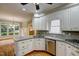 Updated kitchen with white cabinetry, stainless steel appliances, and a breakfast bar at 992 Jones Wynd, Wake Forest, NC 27587