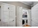 Laundry room with white washer and dryer and built-in shelving at 992 Jones Wynd, Wake Forest, NC 27587