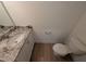 Powder room with granite countertop and white cabinetry at 88 Tradewind Ct, Garner, NC 27529