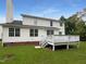 Back of house with deck and grassy backyard at 2200 Wild Apple Ct, Apex, NC 27523