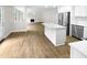 Open kitchen boasting hardwood floors, an island, and stainless steel appliances at 2200 Wild Apple Ct, Apex, NC 27523
