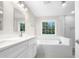 Modern bathroom with double vanity, soaking tub, and glass shower at 2200 Wild Apple Ct, Apex, NC 27523