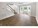 Bright living room featuring hardwood floors, a bay window, and a staircase at 2200 Wild Apple Ct, Apex, NC 27523