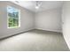 Bright bedroom with carpeted floors and large window at 2200 Wild Apple Ct, Apex, NC 27523