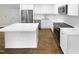 Modern kitchen with white cabinets, stainless steel appliances, and a large island at 2200 Wild Apple Ct, Apex, NC 27523