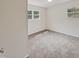 Spacious bedroom with neutral-colored carpet and large windows at 1421 Athens Dr, Raleigh, NC 27606