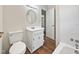 Clean bathroom with white vanity, bathtub, and wood-look flooring at 1421 Athens Dr, Raleigh, NC 27606