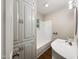 Clean bathroom with a white vanity, bathtub, and built-in storage at 1421 Athens Dr, Raleigh, NC 27606