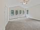 Spacious main bedroom with neutral carpeting and multiple windows at 1421 Athens Dr, Raleigh, NC 27606