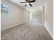 Large bedroom with ceiling fan, carpet, and multiple windows at 1421 Athens Dr, Raleigh, NC 27606