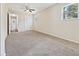 Main bedroom with ceiling fan, carpet, and access to a hallway at 1421 Athens Dr, Raleigh, NC 27606