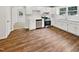 Bright kitchen with white cabinets, stainless steel appliances, and wood-look flooring at 1421 Athens Dr, Raleigh, NC 27606