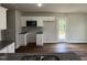 Kitchen with white cabinets, granite counters, and deck access at 153 Wynd Crest Way, Benson, NC 27504