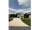 Two-story house with beige siding, black windows, and a concrete driveway at 153 Wynd Crest Way, Benson, NC 27504