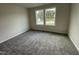 Bright bedroom with carpet flooring and two large windows at 66 Tulipfield Way, Benson, NC 27504