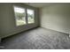 Spacious bedroom with carpet flooring and two large windows at 66 Tulipfield Way, Benson, NC 27504