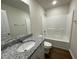 Bathroom with granite vanity, single sink, and bathtub at 66 Tulipfield Way, Benson, NC 27504