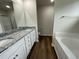Bathroom with double vanity, granite countertop, and bathtub at 66 Tulipfield Way, Benson, NC 27504