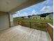 Wooden deck overlooking backyard with homes in distance at 66 Tulipfield Way, Benson, NC 27504
