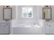 Bathroom with double vanity, soaking tub, and large mirrors at 143 Traceway N, Sanford, NC 27332