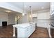 White kitchen island with marble countertop and hardwood floors at 143 Traceway N, Sanford, NC 27332