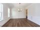Bright dining room features hardwood floors, wainscoting, and elegant chandelier at 143 Traceway N, Sanford, NC 27332